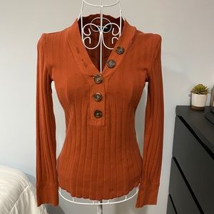 Long sleeve casual shirt with detailed buttons.